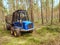 Harvester truck work in young pine forest. Skilful three axes harvester.