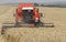 Harvester at work. Wheat field, harvesting, threshing