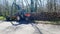 Harvester working tractor loads a wooden trailer in forest