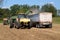 Harvesting equipment unloading soybeans into a hopper truck