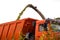 Harvesting fodder corn, the combine grinds the corn and pours into the dump truck