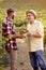 Harvesting grapes in vineyard â€“ satisfied father and son