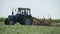 Harvesting herb with a farming tractor