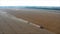 Harvesting machines in the field. Combines of clean wheat. Old harvesters clean the fields of dry corn against the blue evening