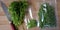 Harvesting parsley leaves for the winter and packing with plastic bags. Greens on a cutting board