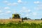 Harvesting rapeseed on a sunny summer day