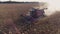 Harvesting sunflower. Fast rides on the field, the sun`s glare in the frame. Airview