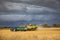 Harvesting under a threatening sky