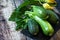 Harvesting zucchini. Healthy uncooked fresh green zucchini on a wooden kitchen table. Copy space.