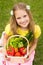 Harvests of vegetables - smiling girl with basket of vegetables