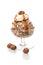 Haselnut ice cream scoop with whipped cream and hazelnuts in a glass