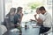 Hashing out ideas in the boardroom. a group of businessmen having a meeting around a table in an office.