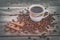 Hashtag as cinnamon sticks on coffee grains with coffee cup on old rustic background