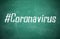 Hashtag Coronavirus written with white chalk on greenboard