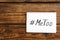 Hashtag METOO in notebook on wooden background, top view. Stop sexual assault