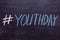 Hashtag YouthDay handwritten text in colored chalk on a chalkboard