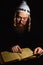 Hasidic jew reading Torah. Religious orthodox jew with sidelocks and red beard in white bale praying in the dark