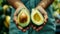 Hass Avocado Harvest: A Female Fruit Sorting Factory Worker Examines Perfectly Ripe Halves in Close-