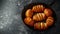 Hasselback baked potatoes served in cast-iron pan with salt, pepper and herbs