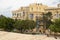 Hastings Garden and  typical residential buildings made of stone with wooden balconies and shutters in Valletta, Malta