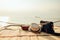 Hat, Bag and Guitar on reed mat near the sea at sunset. Travel, vocation, holiday, summer concept