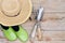 Hat, Gardening Shoes and Tools on Wood Background