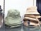 Hat made of lightweight fabric on shelf in shoes store. Mass market shop. Fashionable rain hat. Bucket hat for outdoor activities