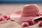 Hat in the sand A holiday mood conveyed with a pink straw hat