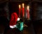 Hat of Santa Claus with gift and chandelier with candles