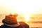 Hat and sunglasses on the rock near the beach and sunset