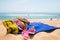 Hat, sunglasses, towel and other items on a sand beach