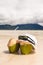 Hat and sunglasses with two coco nut cocktails on beach