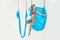 Hatha aero fly yoga concept. Beautiful young female trainer showing stretching exercises on blue hammock in white studio