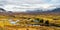 Haukadalur valley in Iceland. Little buildings in peaceful nature environment. Valley landscape sunny autumn day cloudy