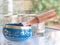 Haulerwijk - march 07 2020: Haulerwijk, The Netherlands. blue and golden indian singing bowl made of seven metals with a