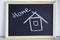 Hause painted with chalk and the inscription home. Wooden chalkboard with picture. Happy, sweet home and family concept.