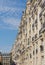 Haussmann apartments line streets in Paris under a blue sky