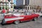 Havana / Cuba - 07/2018: Old and rusty cars of fifties rented in Havana. Red Edsel Pacer from side proection with caucasian woma