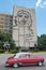 HAVANA, CUBA, AUG 16, 2016: Vintage car drives in front of iconic Che Guevara`s mural at Revolution Square