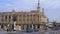 HAVANA, CUBA - MAY 13, 2018 - Panoramic street view of the Great Theatre of Havana in the sunset with vintage cars and