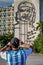 HAVANA - OCTOBER 26- Tourist takes a picture of sculpture of Che Guevara on facade of Ministry of Interior, Plaza de la Revolucio