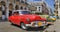 Havana street with colorful old cars in a raw