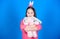 Have blessed Easter. Bunny girl with cute toy on blue background. Child smiling play bunny toy. Happy childhood. Get in