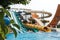 Have fun riding slides in an aquapark. Summer vacation entertainment ideas. Colorful slide variety and turquoise swimming pool at