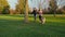 Have fun with your beloved dog. Young multi-ethnic couple running in the park