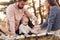 Haves picnic. Happy family of mother, family and little baby rests outdoors. Beautiful sunny autumn nature