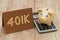 Having a 401k plan, A golden piggy bank, card and calculator on