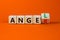 Having anger or being an angel. Turned a wooden cube and changed the word anger to angel. Beautiful orange background. Business