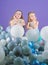 Having fun concept. Balloon birthday party. Girls little siblings near air balloons. Birthday party. Happiness and