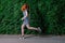 Having fun. Young redhead girl having fun in front of grape wall, copyspace